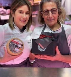 Local vendors presenting Idiazabal cheese at a market in San Sebastian